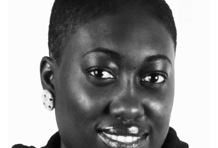 Imade Nibokun, a Black woman with short hair smiling