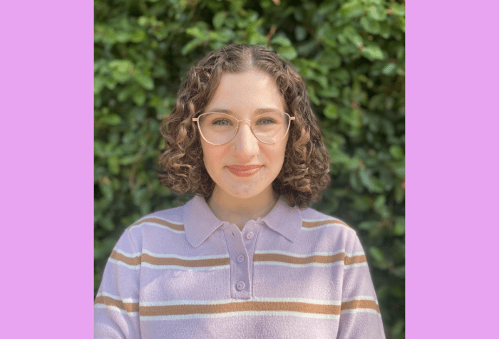 Graphic with a lilac background with a headshot of Sabrina Epstein, a young white woman with curly, shoulder-length brown hair and glasses, wearing a purple striped sweater. Greenery is visible behind her.